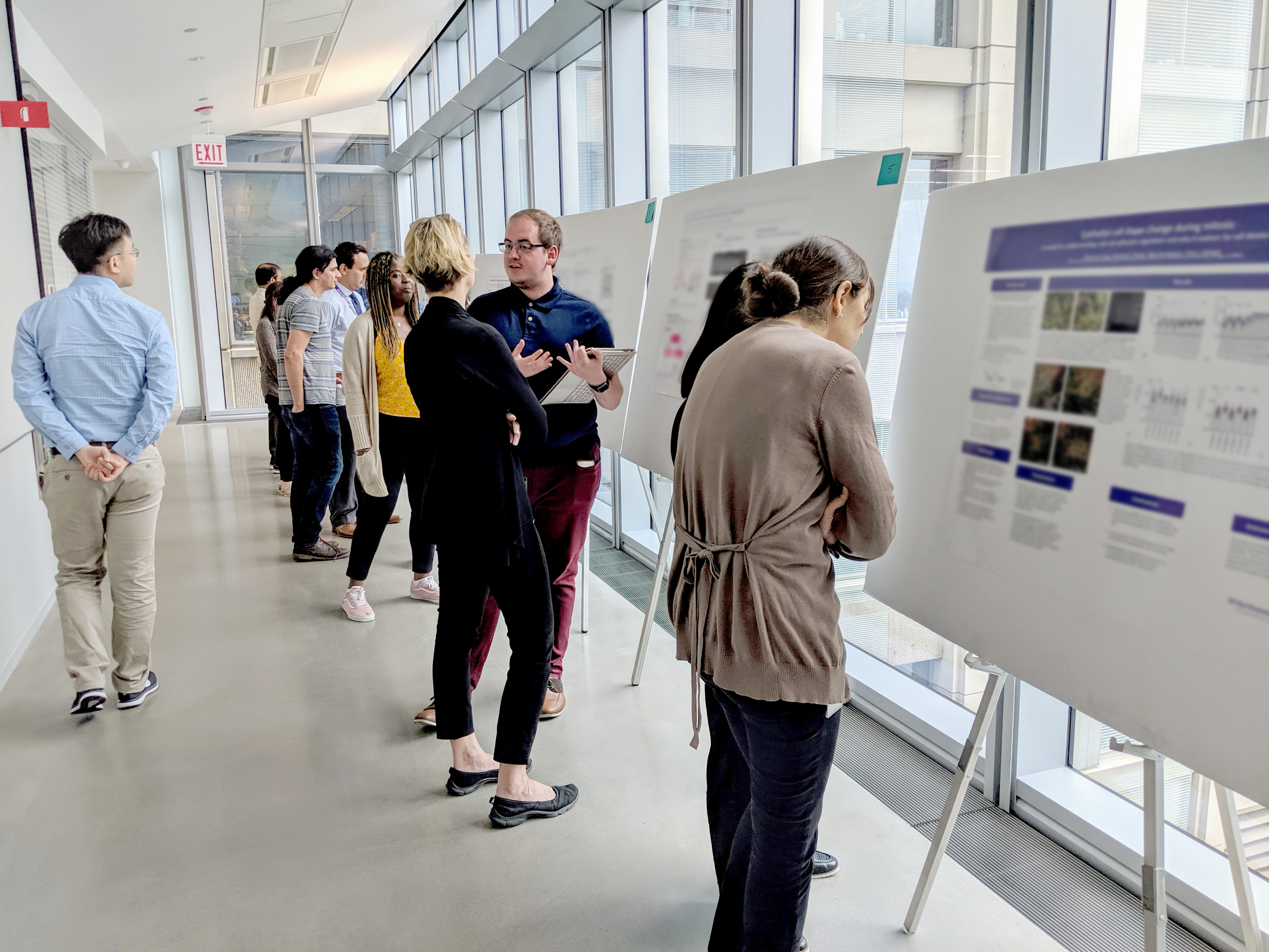 Interns present their posters at the Summer Research Symposium